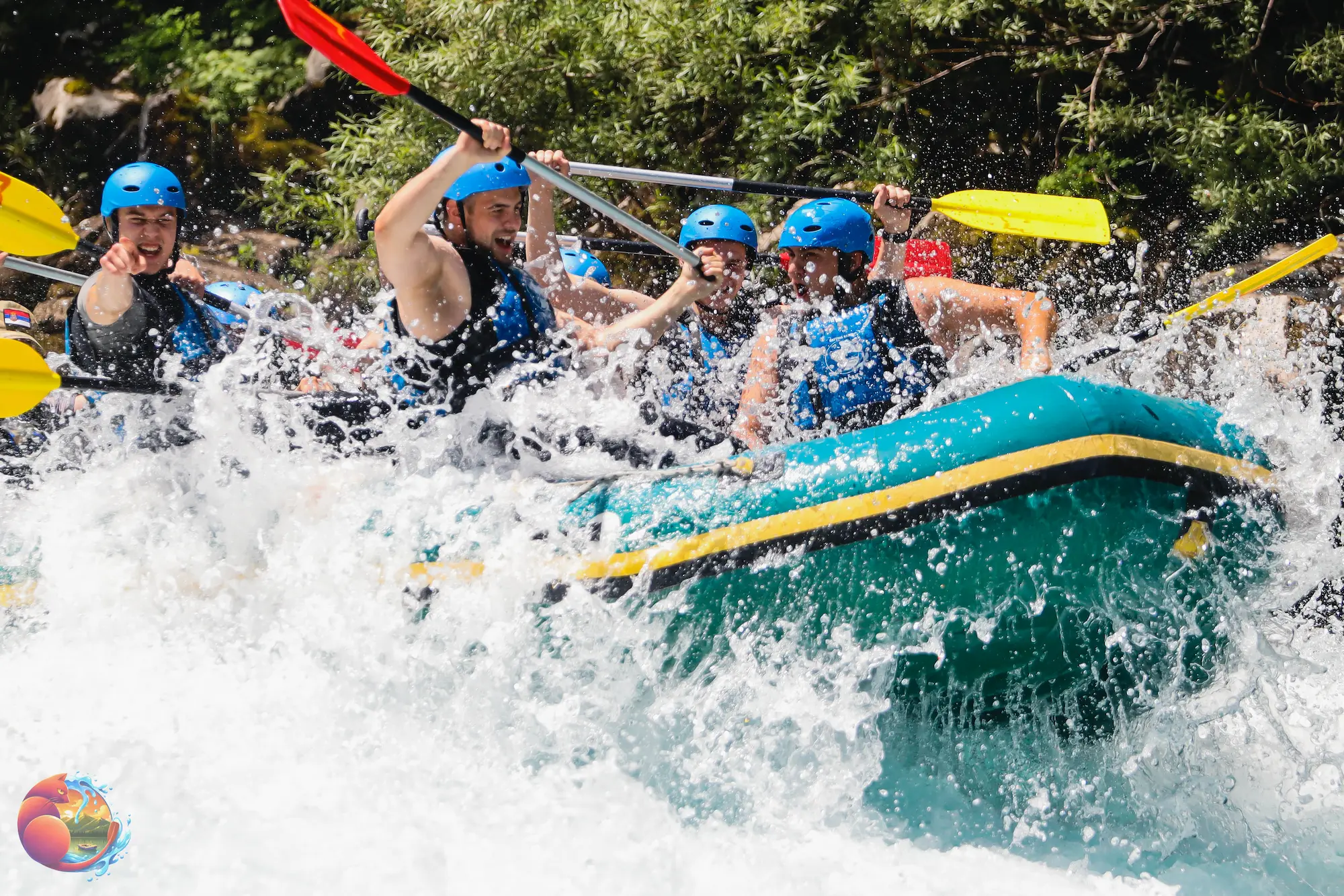 Naslovna Group of people white-water rafting, wearing blue helmets and life jackets, paddling through turbulent rapids with excitement and determination.