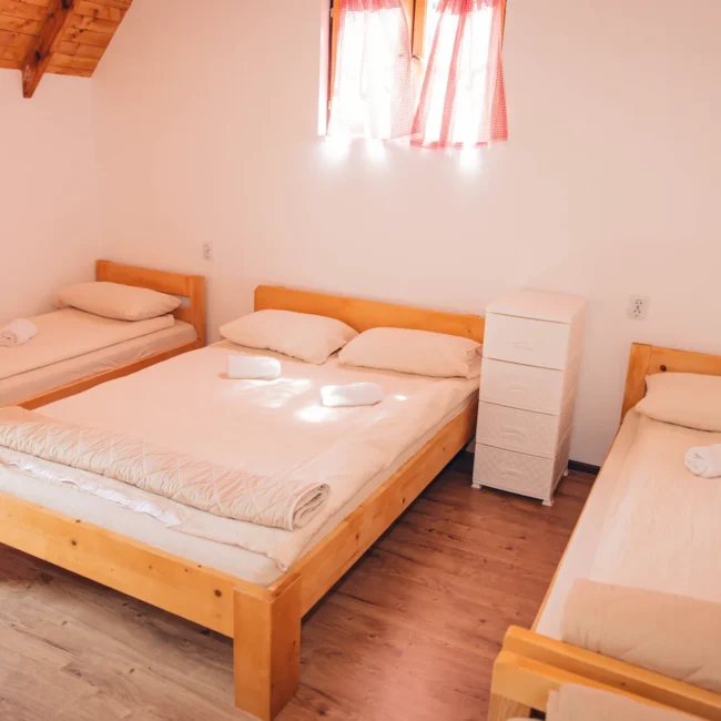 3 beds inside in a neat, clean room.