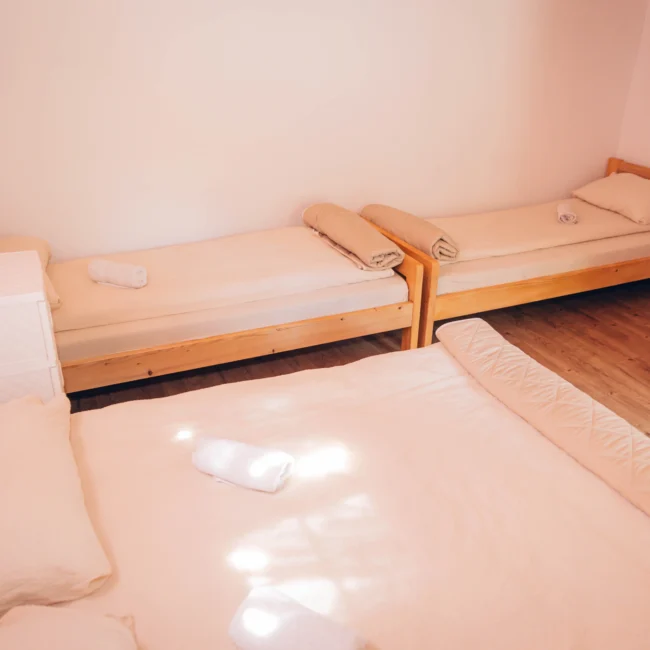 inside of a bungalow, 3 beds with clean sheets