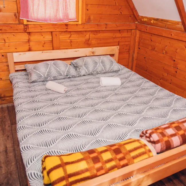 clean, neat wooden bed for 2 people