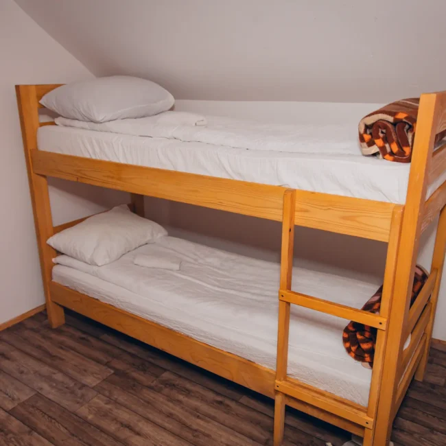 wooden bunk bed with clen, neat sheets